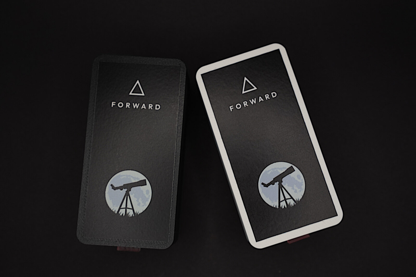 Two Stargraph units side-by-side showing the different color options. Lunar white and Space Black. Each unit has a label with the Stargraph logo and text saying 'Forward' at the top.